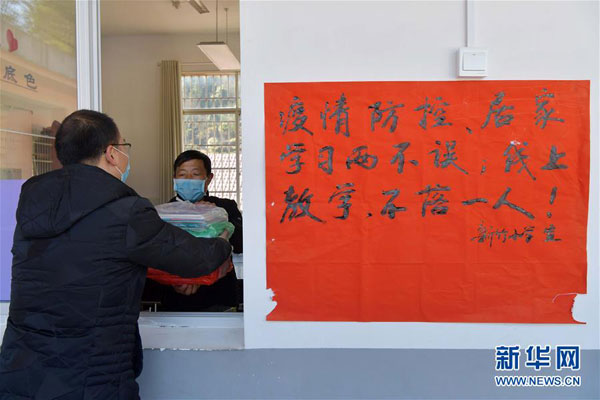 2月17日，在江西省万载县高村镇新竹村新竹小学，罗长石领取了新学期的书本，准备给学生们带去。 新华社记者 彭昭之 摄