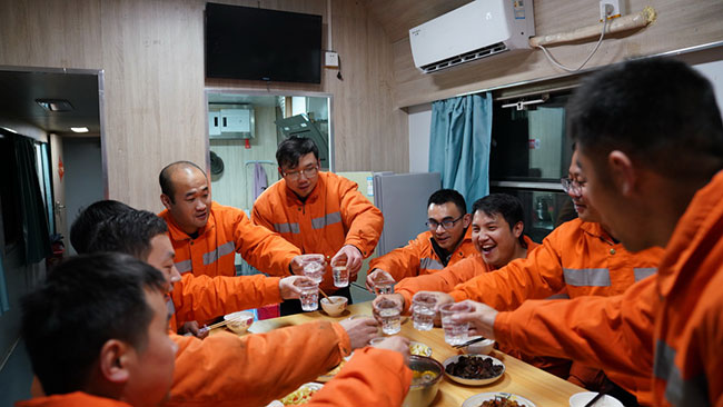工作完成后，鹰潭工务机械段工作人员在宿营车内就餐（1月27日摄）。