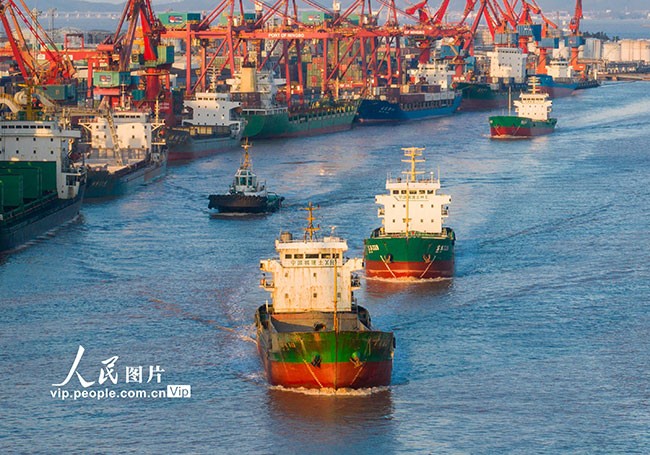 浙江省宁波舟山港镇海港码头外甬江中往来的货轮。
